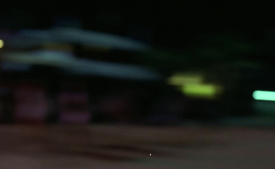 a blurry photo of a parking meter at night