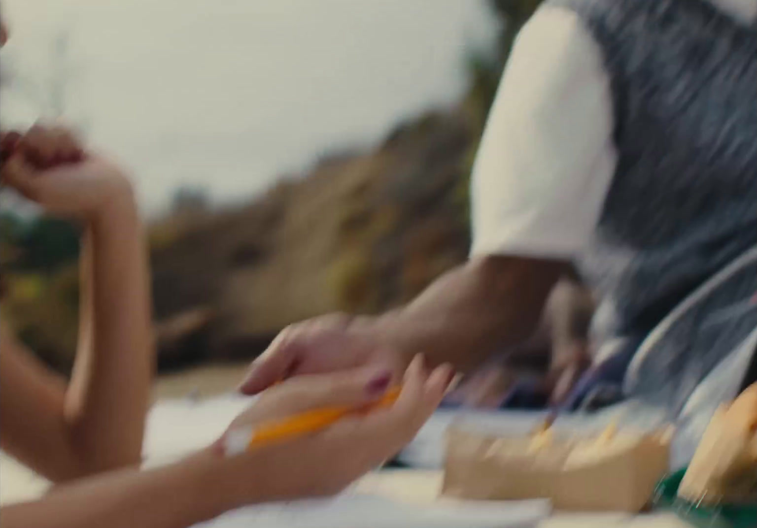 a man and a woman sitting at a table with food