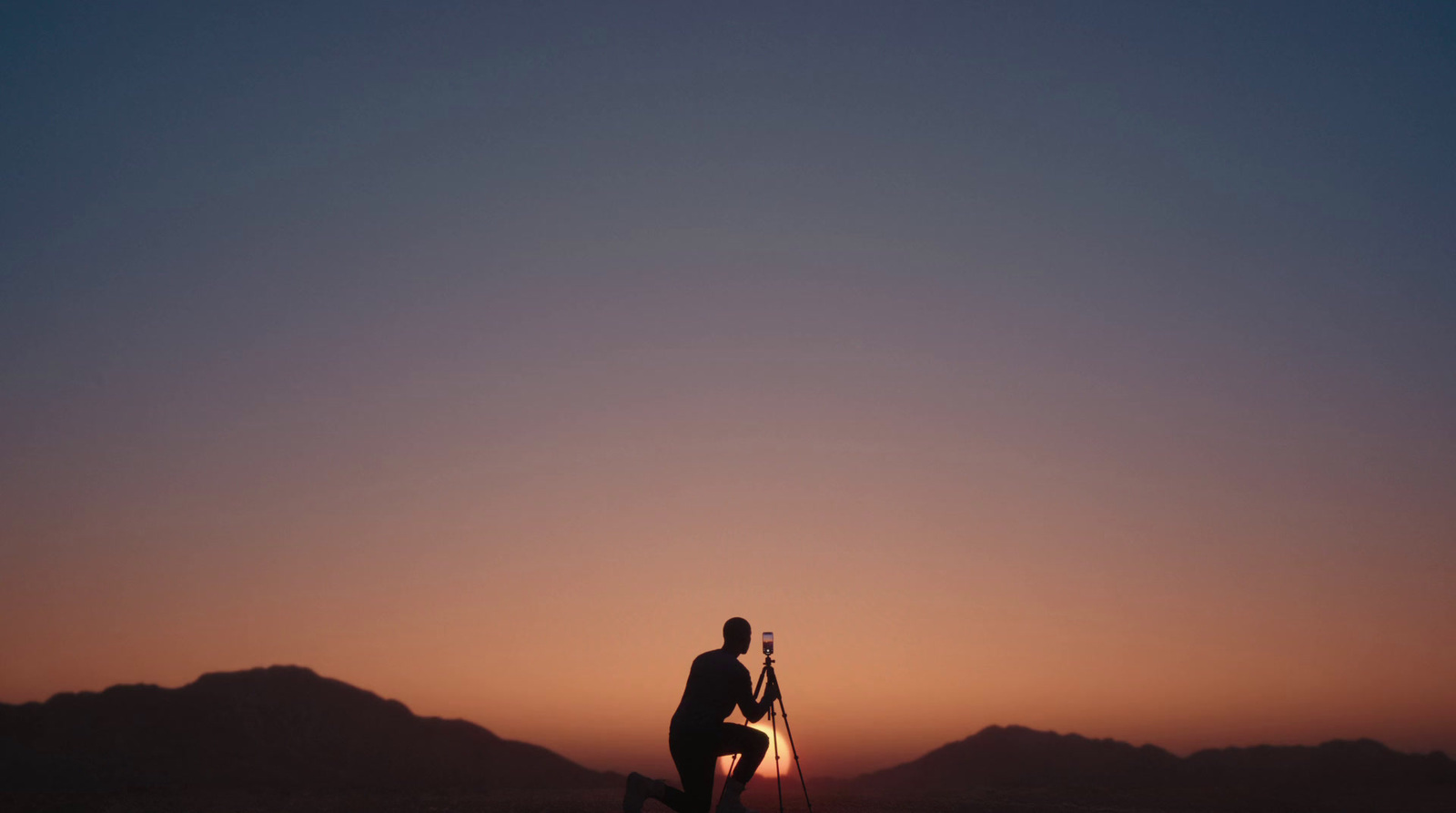 a man standing on top of a snow covered slope