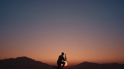 a man standing on top of a snow covered slope