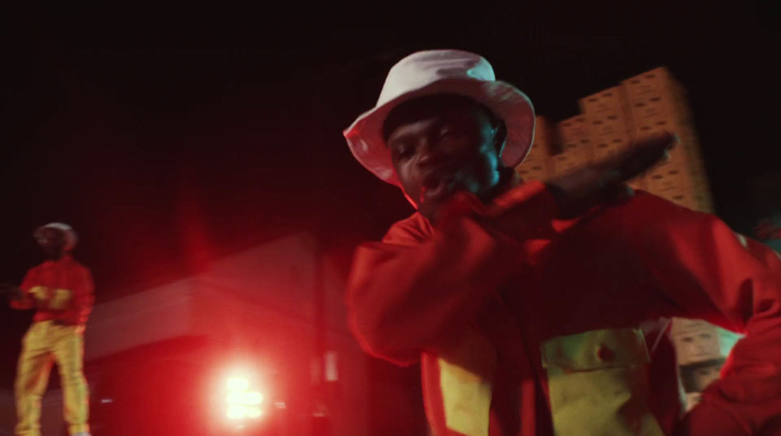 a man in a red jacket and a white hat