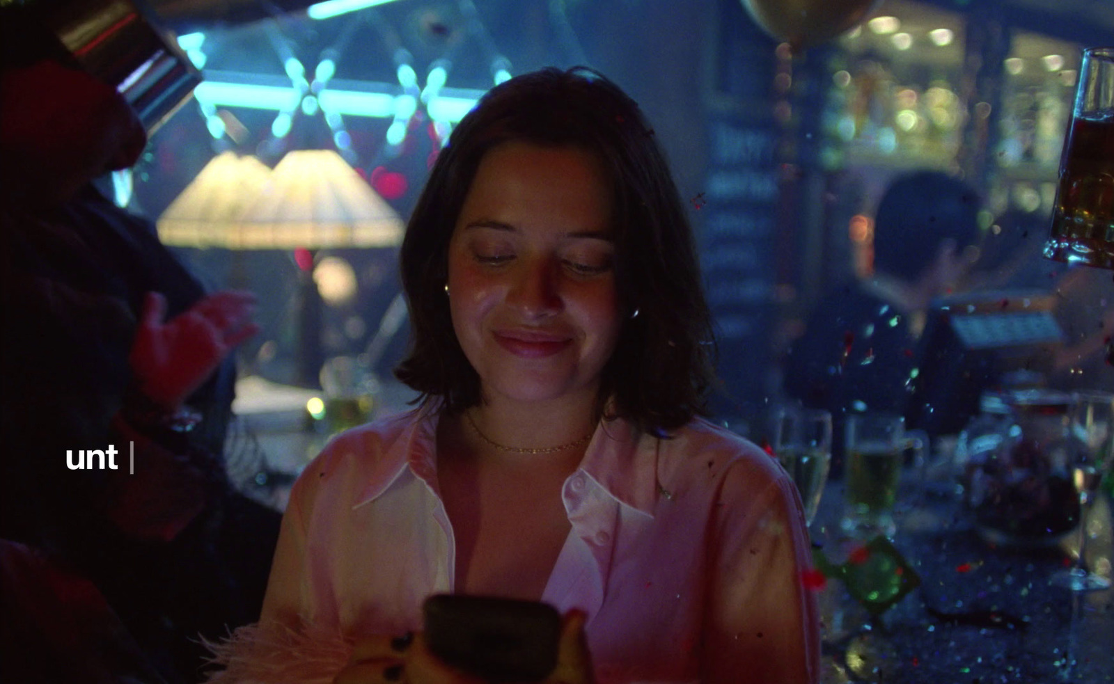 a woman looking at her cell phone in a restaurant