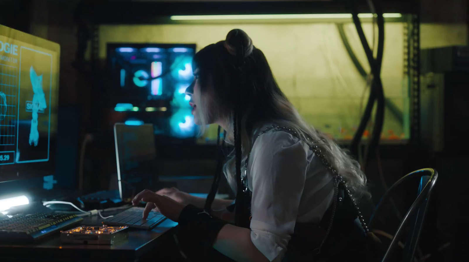 a woman sitting in front of a laptop computer