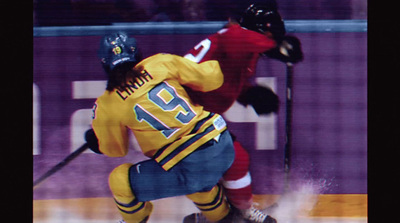 a couple of men playing a game of ice hockey