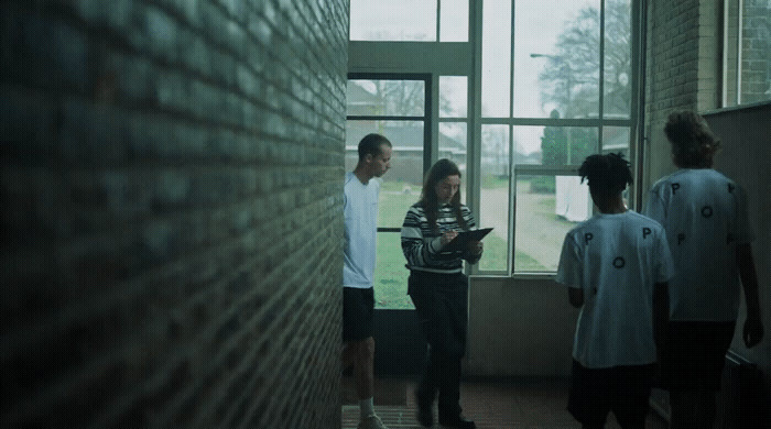 a group of people standing in front of a window