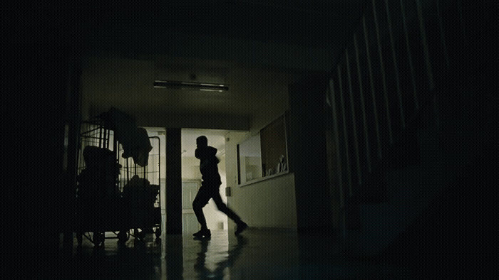 a person walking in a dark hallway in a house