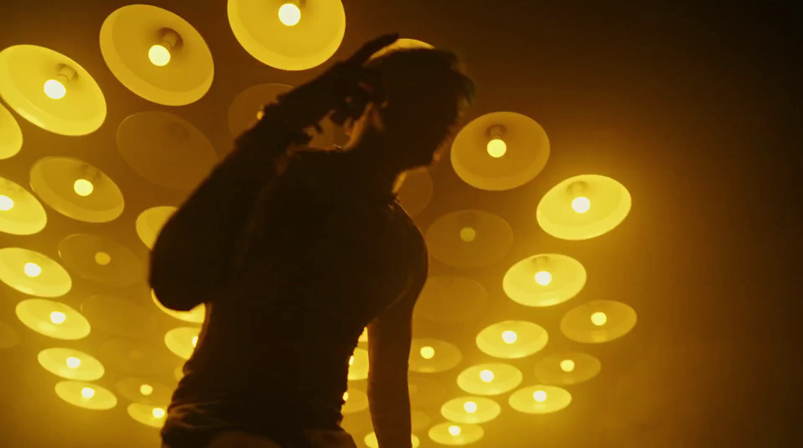 a woman standing in front of a wall of lights