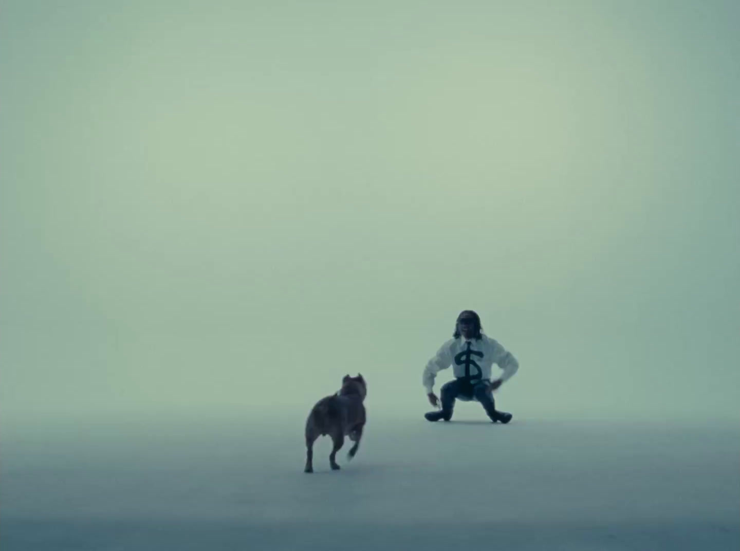 a person kneeling down next to a dog