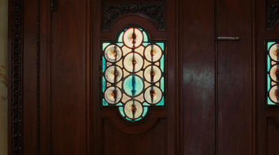 a close up of a wooden door with stained glass