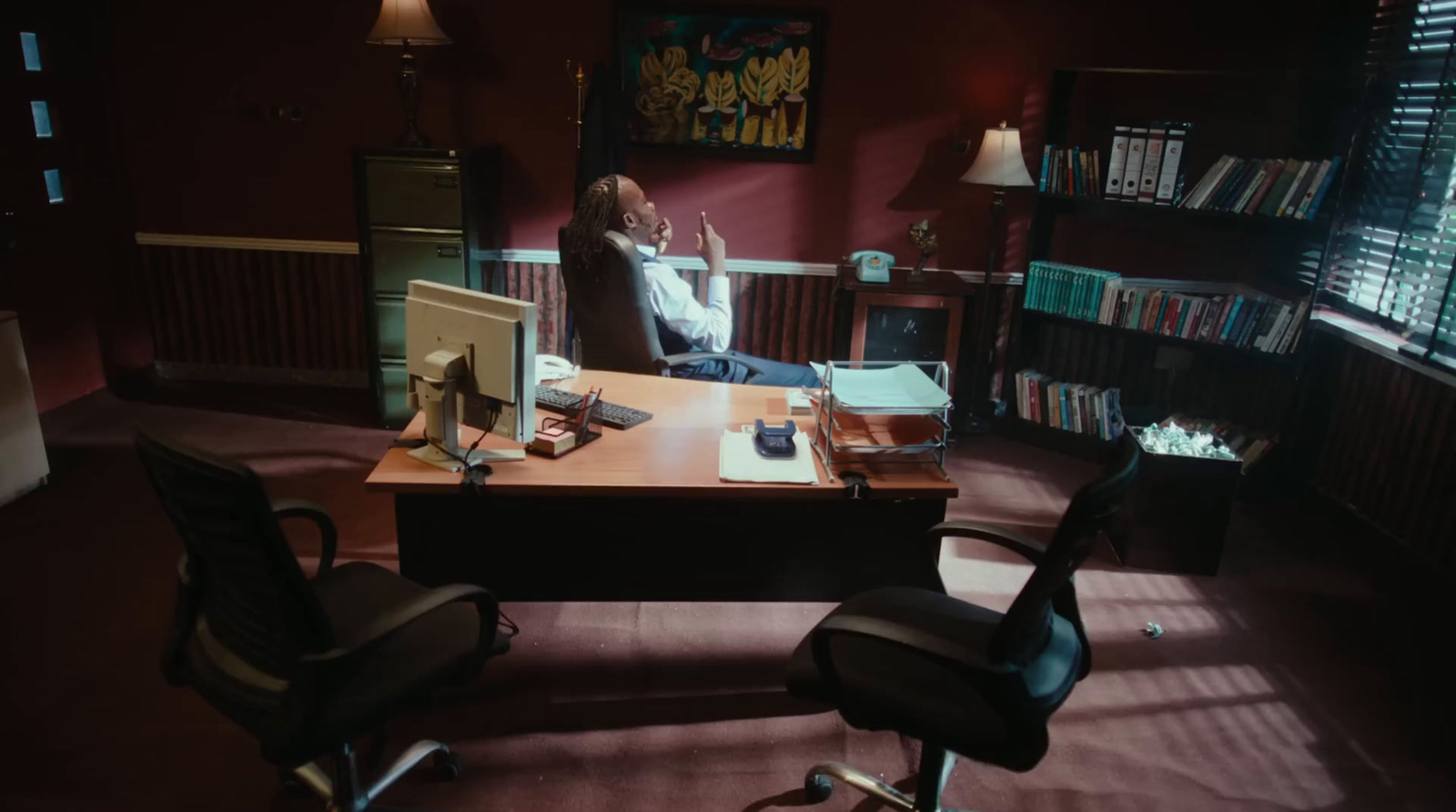 a person sitting at a desk in a room