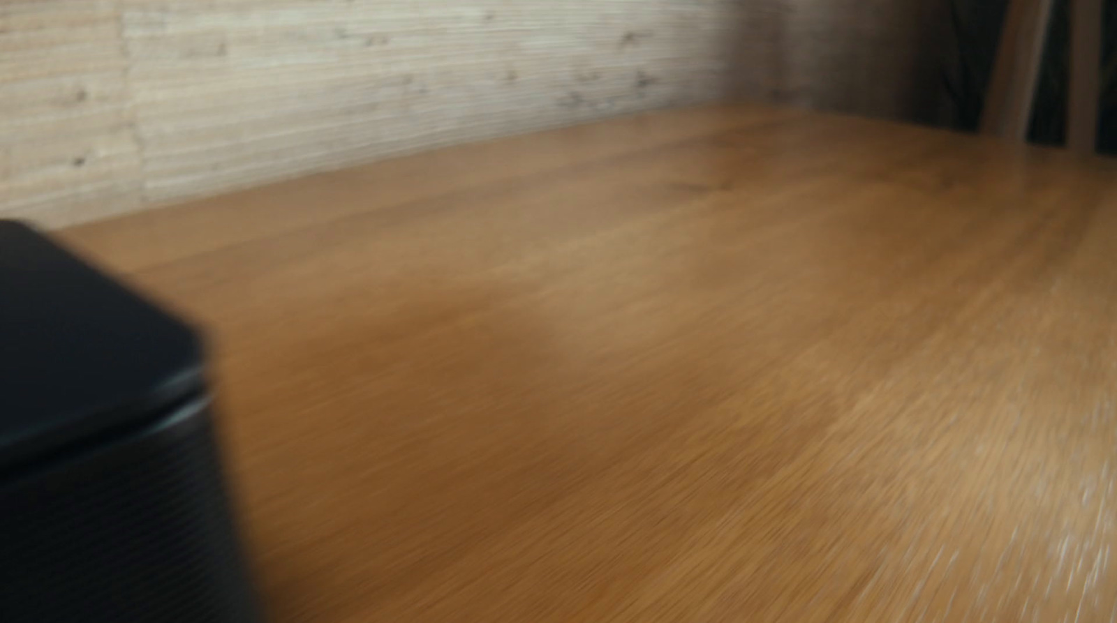 a blurry photo of a room with a wood floor