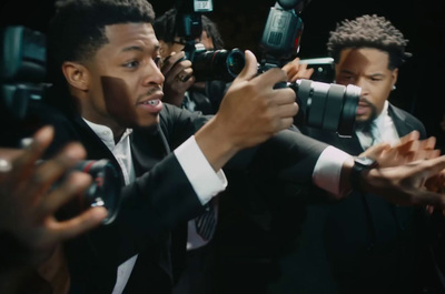 a man in a suit taking a picture with a camera