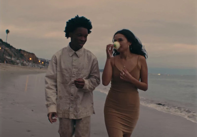 a man and a woman walking on the beach