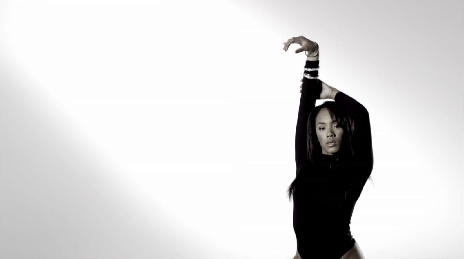 a woman in a black bodysuit doing a dance pose