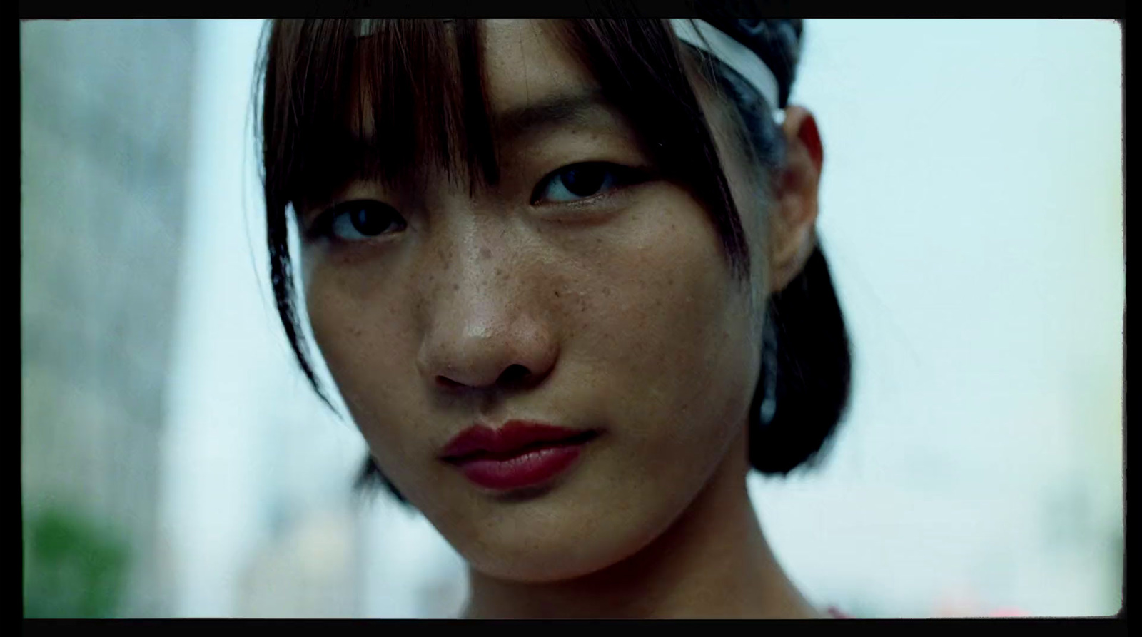 a close up of a woman with freckles on her hair