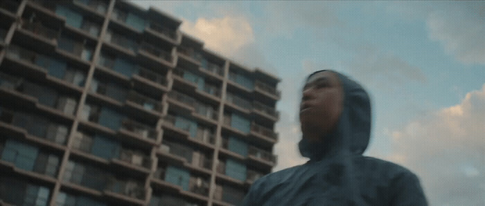 a blurry photo of a person standing in front of a tall building