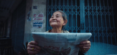 a woman holding a newspaper in her hands