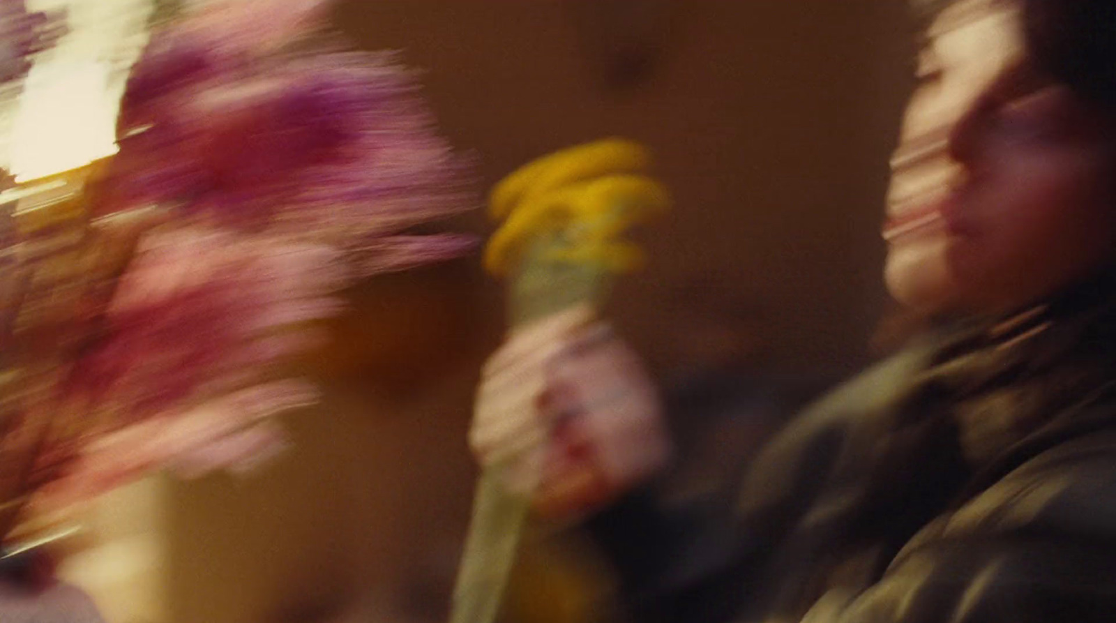 a blurry photo of a woman holding a bouquet of flowers