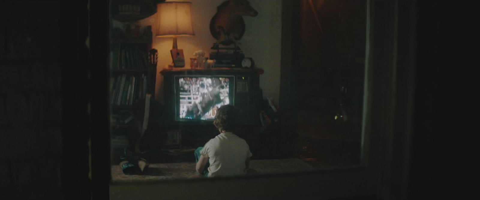 a person sitting in front of a tv in a living room