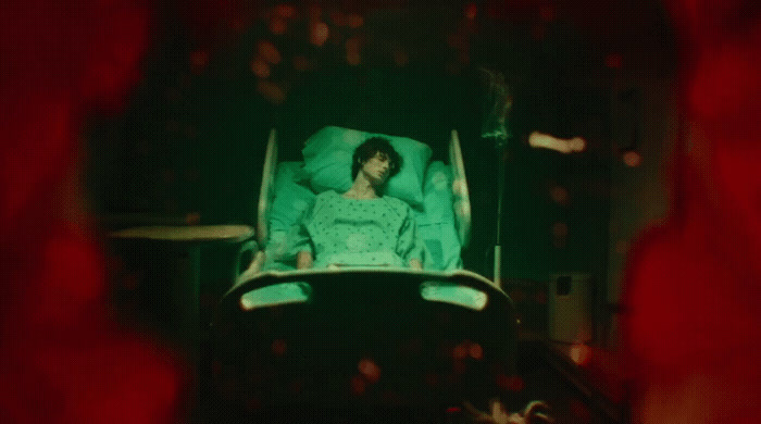 a woman laying in a reclining chair in a dark room