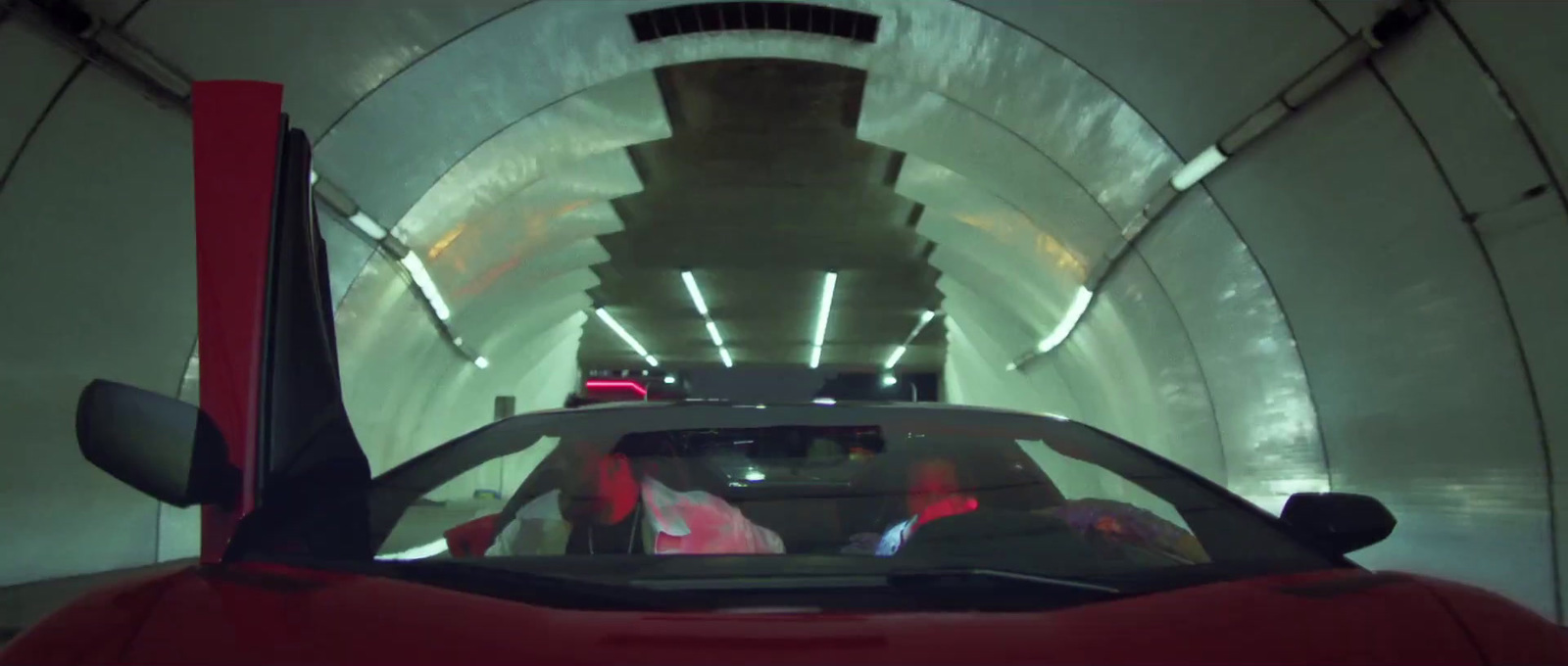 a red sports car driving through a tunnel