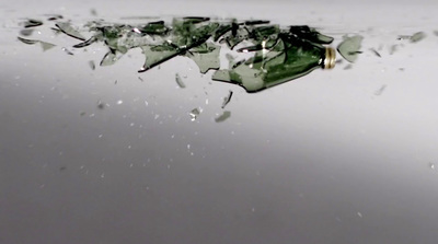 a broken glass bottle floating in the water