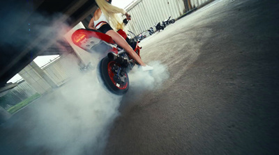 a woman riding on the back of a red motorcycle