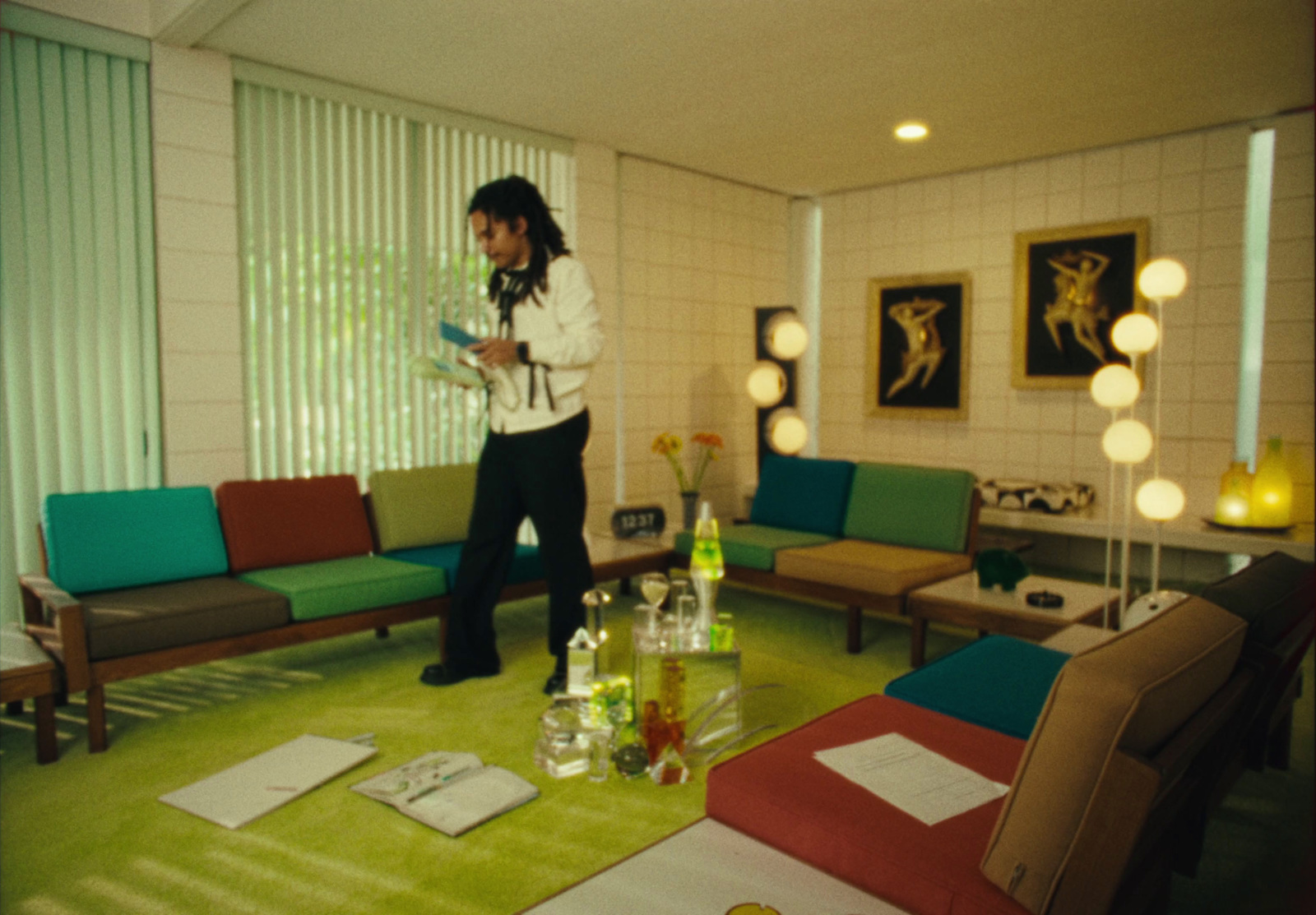 a man standing in a living room next to a couch