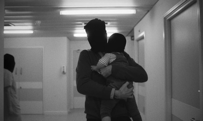 a man holding a child in a hallway