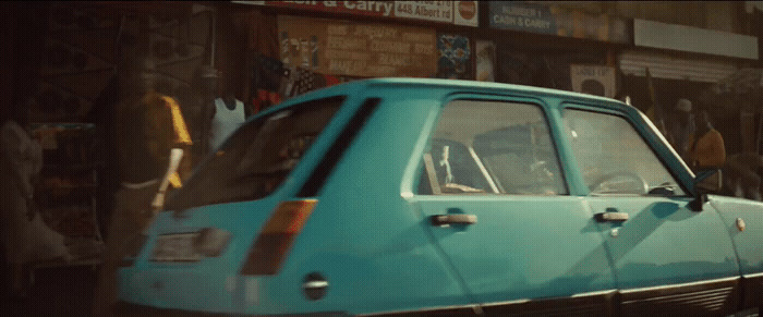 a blue car parked on the side of a street