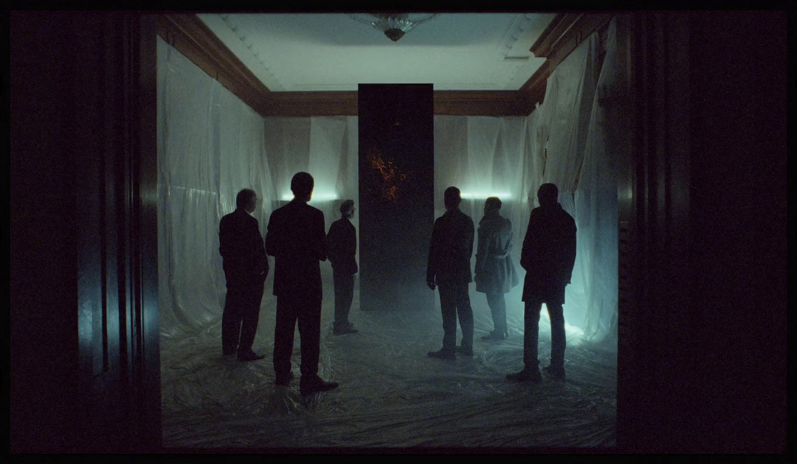 a group of people standing in a dark hallway