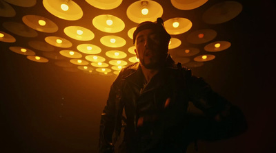 a man standing in front of a light filled ceiling