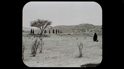 a black and white photo of a person in a field