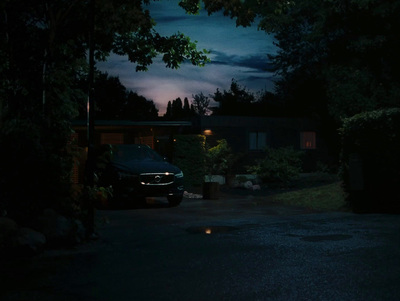 a car parked in a driveway at night