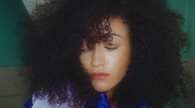 a close up of a person with curly hair