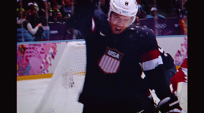 a hockey player holding his arms in the air