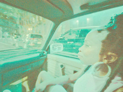 a woman sitting in a car looking out the window