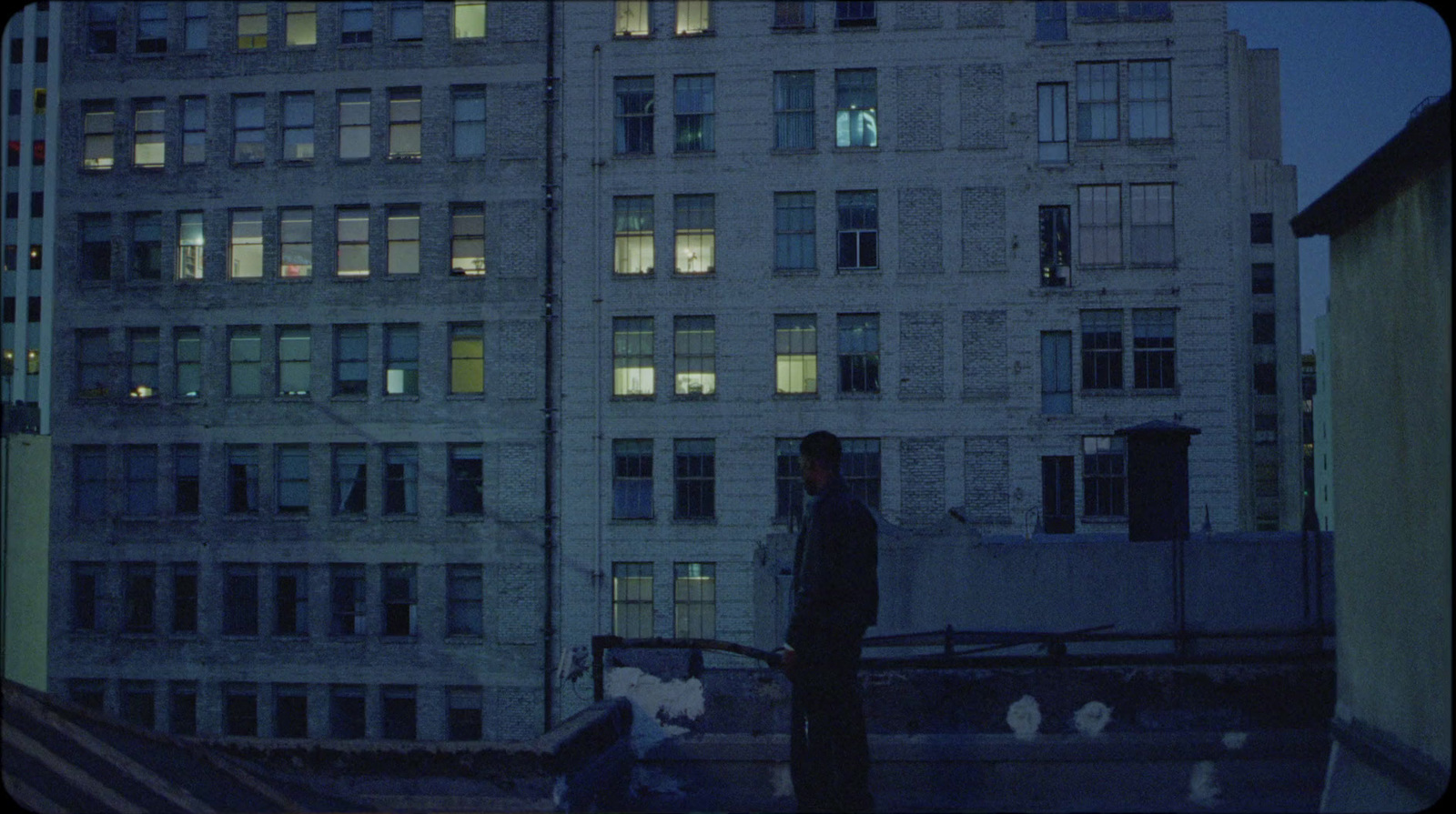 a tall building with lots of windows at night