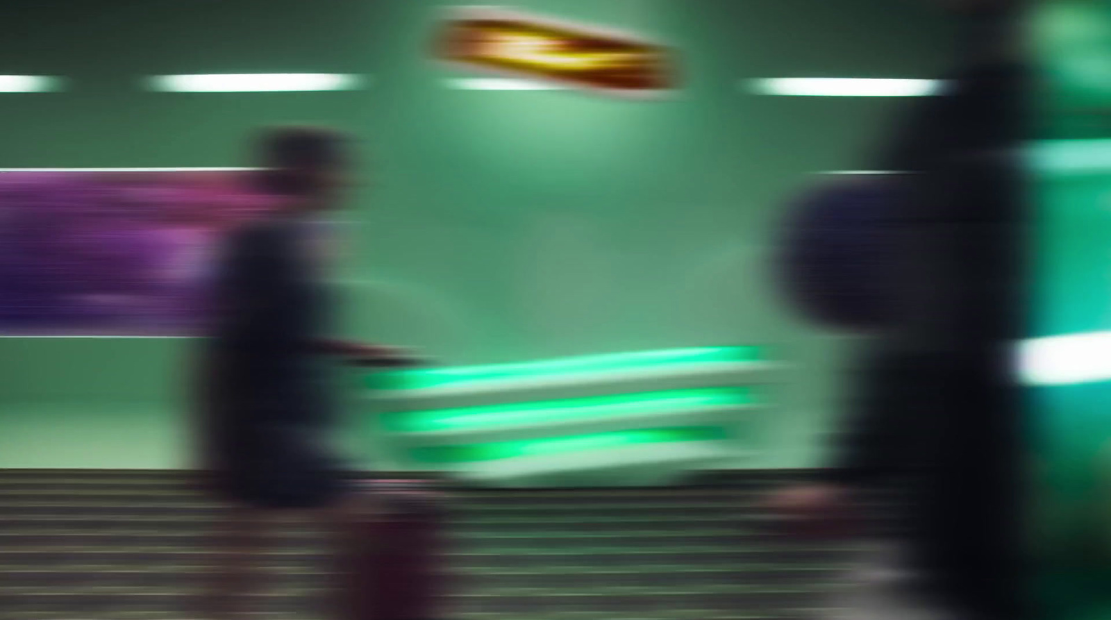 a blurry photo of people walking down a flight of stairs