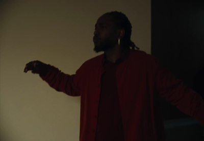 a man with dreadlocks standing in a room