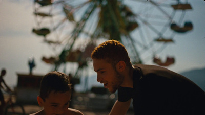 a man and a boy looking at a cell phone