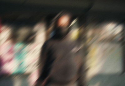 a blurry photo of a man walking down a street