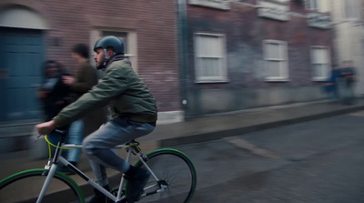 a man riding a bike down a city street