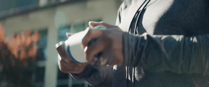 a close up of a person holding a cup