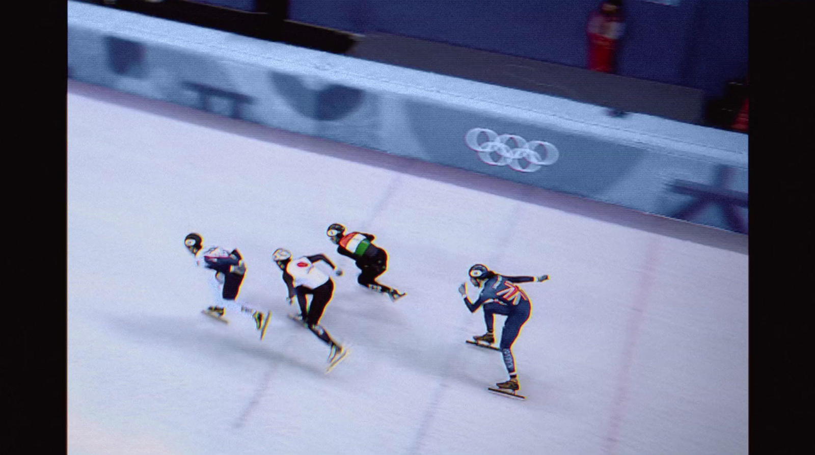 a group of people riding skateboards down a snow covered slope