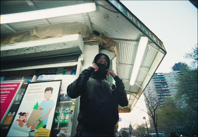 a man standing in front of a building talking on a cell phone