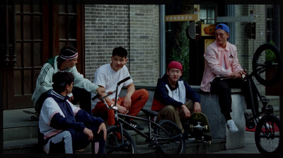 a group of young men sitting on the steps of a building