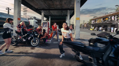 a group of people standing around a motorcycle