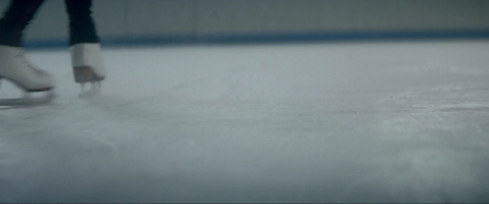 a person skating on an ice rink in the snow