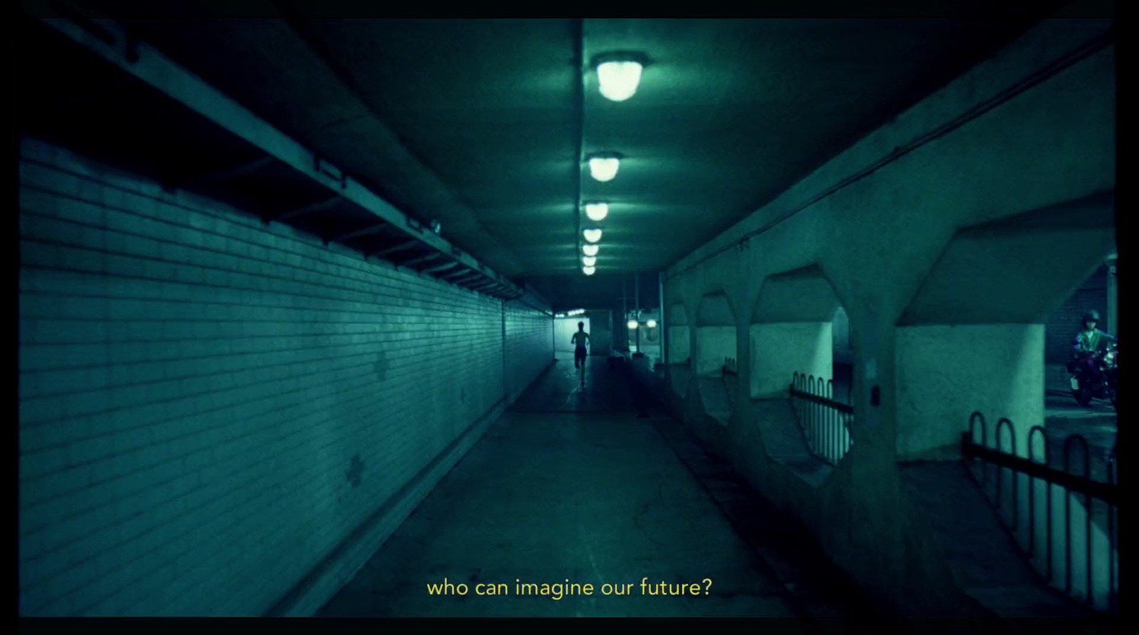 a dark hallway with a person walking down it